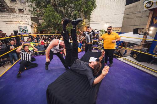 Tyler Colton slams Sweet Bobby Schink into a table during the Rumble in the Burt contract at Blue Note Park. (Supplied photo by Dwayne Larson)