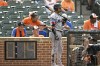 FILE - Miami Marlins' Luis Arraez stand in the on-deck circle next to the pitch clock during the ninth inning of a baseball game against the Baltimore Orioles, July 16, 2023, in Baltimore. Major League Baseball is keeping the pitch clock the same for the postseason as it was for the regular season, brushing aside complaints from some players. (AP Photo/Terrance Williams, File)