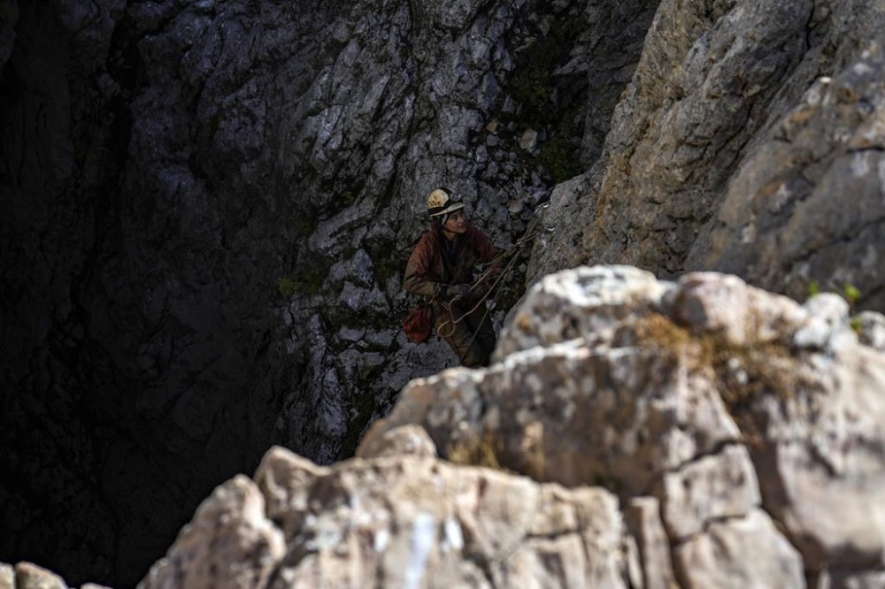 A European Cave Rescue Association (ECRA) member, goes down into the Morca cave near Anamur, southern Turkey, Friday, Sept. 8, 2023. Turkish and international cave rescue experts are working to save an American speleologist trapped at a depth of more than 1,000 meters (3,280 feet) in a cave in southern Turkey after he became ill. (AP Photo/Khalil Hamra)