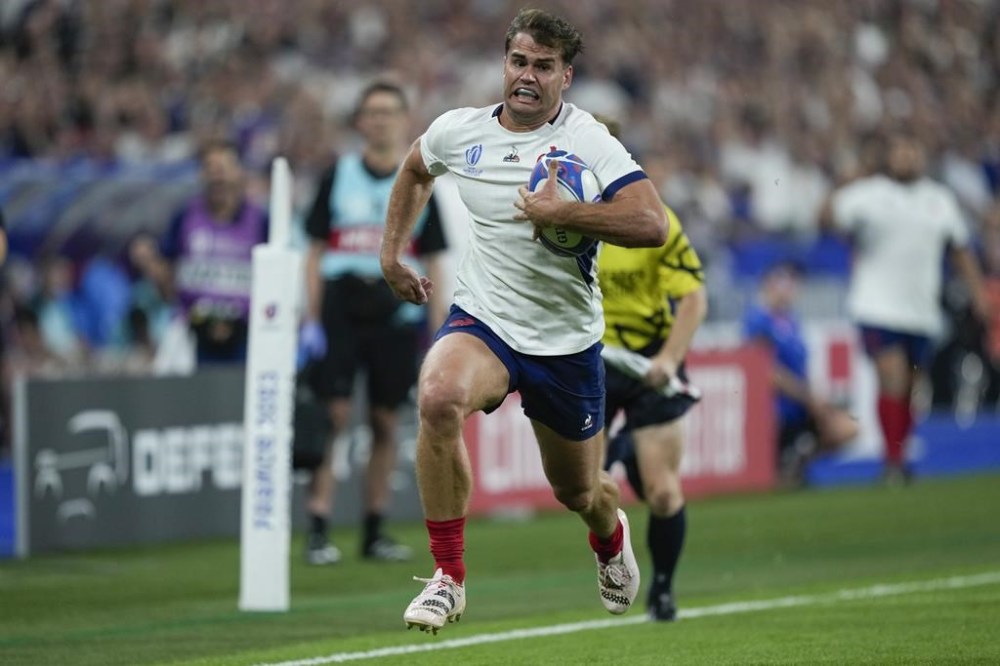 France's Damian Penaud runs with the ball during the Rugby World Cup Pool A match between France and New Zealand at the Stade de France in Saint-Denis, north of Paris, Friday, Sept. 8, 2023. (AP Photo/Lewis Joly)