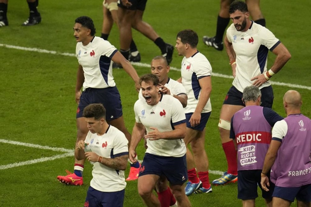 France's Damian Penaud, center, celebrates after scoring a try during the Rugby World Cup Pool A match between France and New Zealand at the Stade de France in Saint-Denis, north of Paris, Friday, Sept. 8, 2023. (AP Photo/Themba Hadebe)