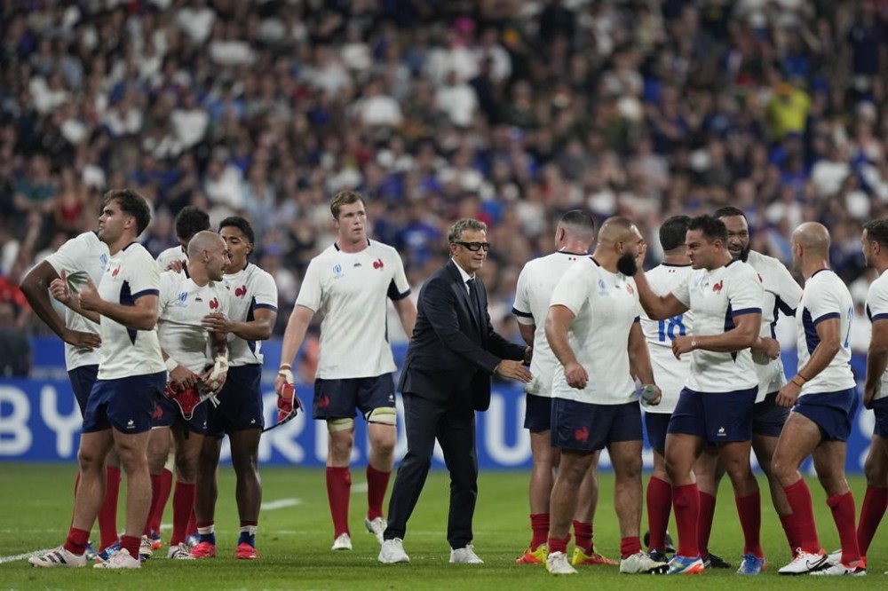 France's head coach Fabien Galthie, center, celebrates with his players at the end of the Rugby World Cup Pool A match between France and New Zealand at the Stade de France in Saint-Denis, north of Paris, Friday, Sept. 8, 2023. France won 27-13. (AP Photo/Lewis Joly)