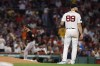 Boston Red Sox starting pitcher Tanner Houck (89) stands off the mound after giving up a solo home run to Baltimore Orioles' Ryan O'Hearn, back left, during the fourth inning of a baseball game, Friday, Sept. 8, 2023, in Boston. (AP Photo/Michael Dwyer)
