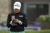 Minjee Lee, of Australia, writes in her scorecard as she stands on the ninth green during the first round of the LPGA Tour Kroger Queen City Championship golf tournament in Cincinnati, Thursday, Sept. 7, 2023. (AP Photo/Aaron Doster)