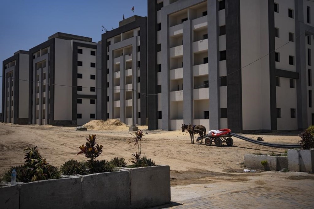 Egyptian-funded residential buildings are near completion in the northern Gaza Strip, Sunday, Aug. 27, 2023. Scores of displayed Palestinian families are awaiting completion of nearly 1,400 homes, but the project has become mired in political disputes between the Palestinian Authority and Gaza’s Hamas-run government. (AP Photo/Fatima Shbair)
