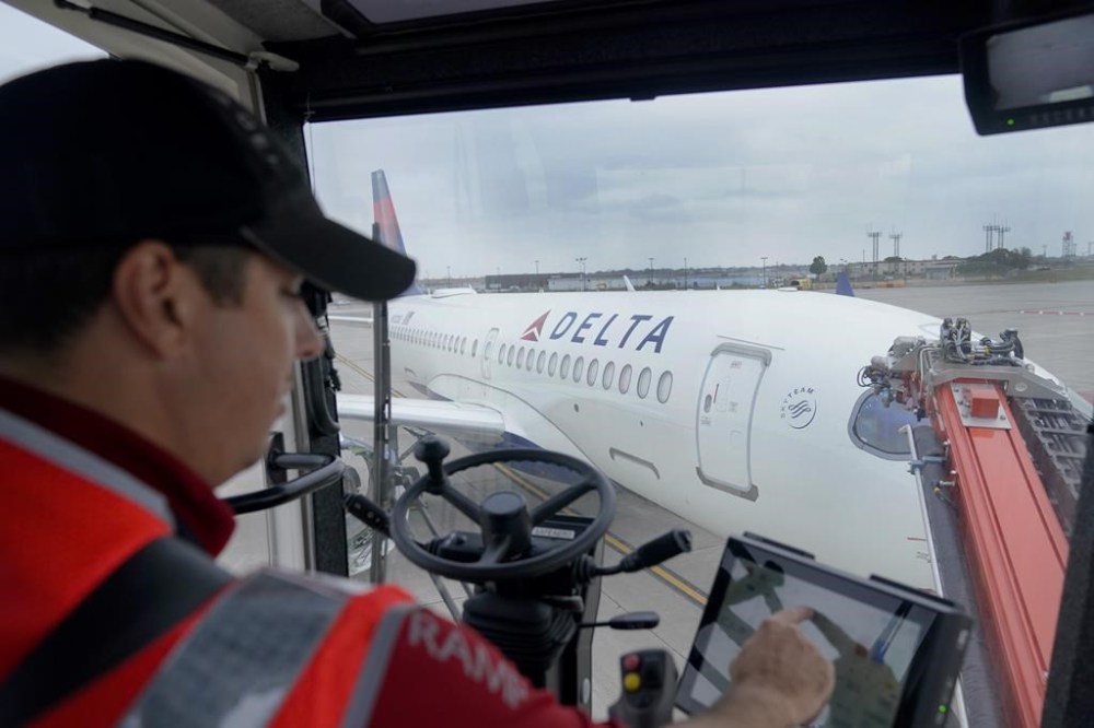 Kevin Smigelski, a certified deice instructor for Delta Air Lines, demonstrates deicing practices on an Airbus A220 to prepare for winter weather at Minneapolis-St. Paul airport, Wednesday, Sept. 6, 2023, in Minneapolis. (AP Photo/Abbie Parr)