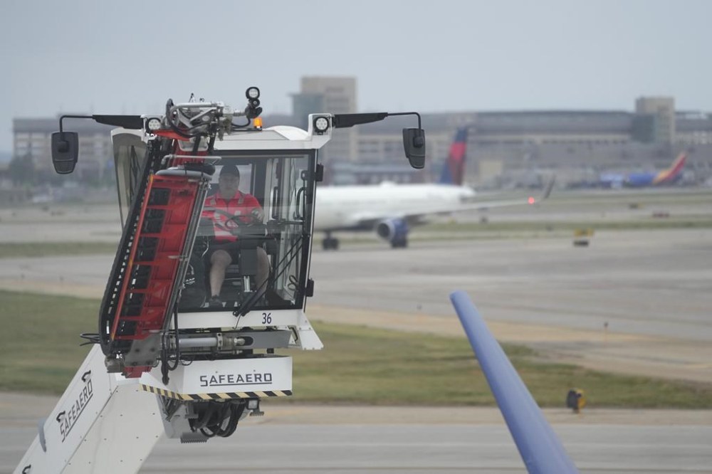 A certified deice instructor for Delta Air Lines demonstrates deicing practices on an Airbus A220 to prepare for winter weather at Minneapolis-St. Paul airport, Wednesday, Sept. 6, 2023, in Minneapolis. (AP Photo/Abbie Parr)
