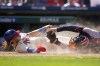 Philadelphia Phillies' Alec Bohm, left, is tagged out by Atlanta Braves catcher Travis d'Arnaud while trying to score on a run-scoring double by Bryson Stott during the fifth inning of the first baseball game in a doubleheader, Monday, Sept. 11, 2023, in Philadelphia. (AP Photo/Matt Slocum)