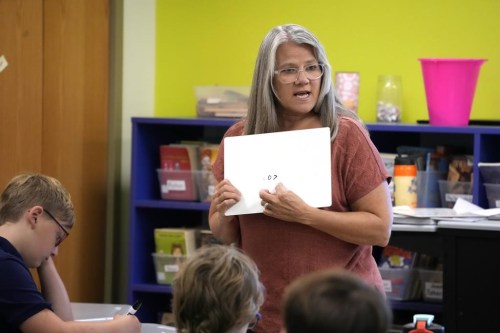 Elementary math teacher Margie Howells teaches a fifth grade class at Wheeling Country Day School in Wheeling, W.Va., on Tuesday, Sept. 5, 2023. Howells said that she turned to the science of math after wondering why there weren't as many resources for dyscalculia as there were for dyslexia. Reading the research helped her become more explicit about things that she assumed students understood, like the fact that the horizontal line in a fraction means the same thing as a division sign. 