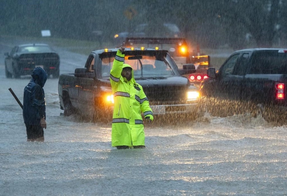 Vehicles make their way through a flooded Lancaster Street during heavy rain in Leominster, Mass., Monday, Sept. 11, 2023. (Rick Cinclair/Worcester Telegram & Gazette via AP)