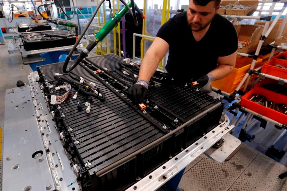 A Renault employee works on the batteries of the the Zoe electric car, on the assembly line of the Renault plant in Flins, west of Paris, France, Wednesday, April 20, 2016. The mining of minerals critical to electric vehicle batteries and other green technologies in Congo has led to human rights abuses, including forced evictions and physical assault. That's according to a report Tuesday from Amnesty International and another rights group. (AP Photo/Francois Mori)