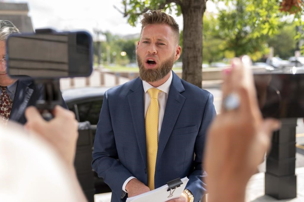 Infowars host Owen Shroyer, speaks to reporters outside the E. Barrett Prettyman U.S. Federal Courthouse, Tuesday, Sept. 12, 2023 in Washington. Shroyer was sentenced on Tuesday to two months behind bars for joining the mob's riot at the U.S. Capitol. Prosecutors said Shroyer “helped create