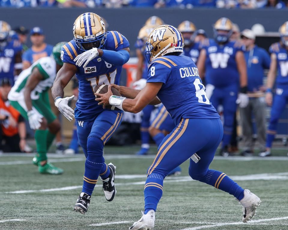 Winnipeg Blue Bombers quarterback Zach Collaros (8) fakes the handoff to Rasheed Bailey (88) during the first half of CFL football action against the Saskatchewan Roughriders in Winnipeg Saturday, September 9, 2023. Collaros, Brady Oliveira and the Blue Bombers' offensive line were graded as some of the top performers Tuesday in the CFL's weekly honour roll. THE CANADIAN PRESS/John Woods