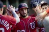 Washington Nationals' Keibert Ruiz celebrates in the dugout after scoring against the Pittsburgh Pirates during the fourth inning of a baseball game in Pittsburgh, Tuesday, Sept. 12, 2023. (AP Photo/Matt Freed)