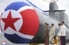 FILE - In this photo provided by the North Korean government, North Korea leader Kim Jong Un, second left, looks at what it says is a new nuclear attack submarine 