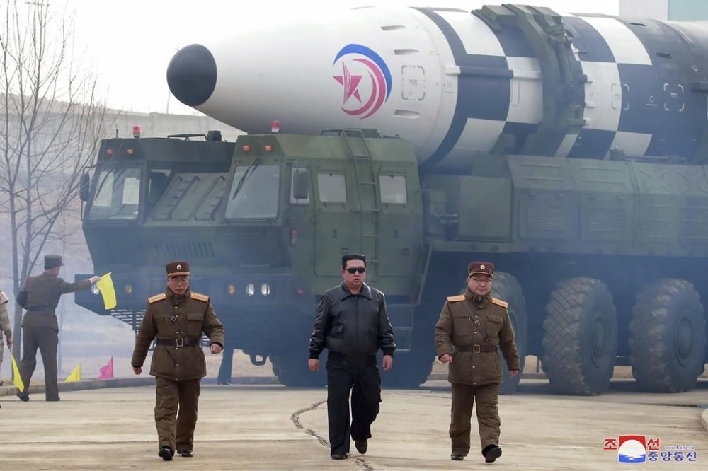 FILE - In this photo distributed by the North Korean government, North Korean leader Kim Jong Un, center, walks around what it says is a Hwasong-17 intercontinental ballistic missile (ICBM) on the launcher at an undisclosed location in North Korea on March 24, 2022. Independent journalists were not given access to cover the event depicted in this image distributed by the North Korean government. The content of this image is as provided and cannot be independently verified. Korean language watermark on image as provided by source reads: