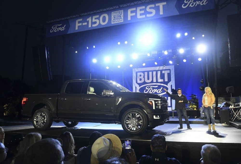 Milton Wong, Chief Program Engineer, F-150, talks about the 2024 Ford F-150 during a reveal at F-150 Fest in Detroit, on Tuesday, Sept. 12, 2023. Emcee Cristy Lee is at right. (Robin Buckson/Detroit News via AP)