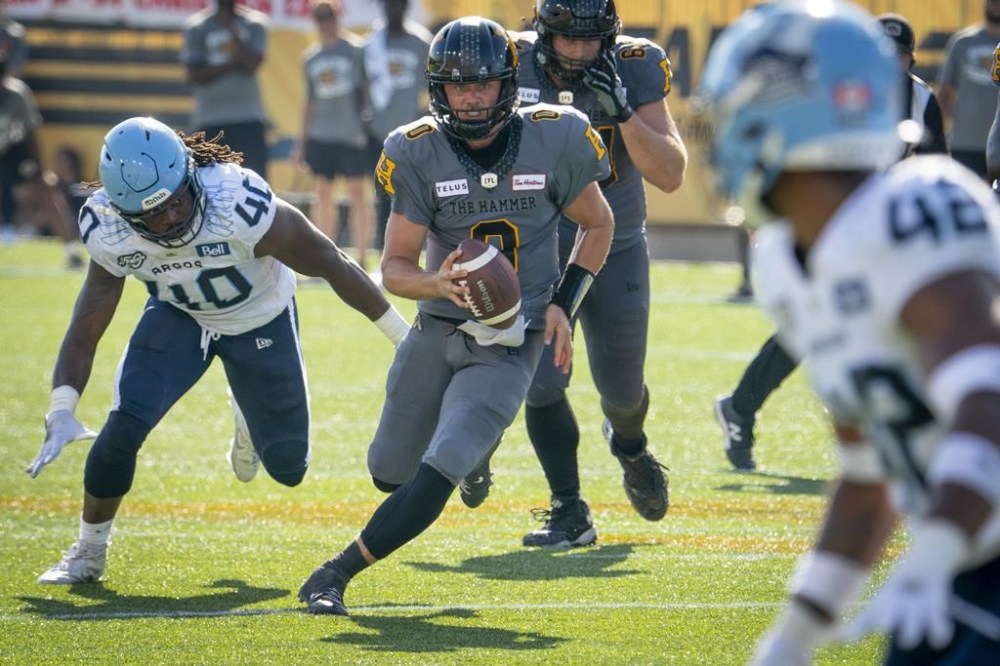Hamilton Tiger-Cats quarterback Taylor Powell (0) runs under pressure during CFL action against the Toronto Argonauts in the annual Labour Day Classic in Hamilton, Ont. on Monday, September 4, 2023. They don’t face another ridiculously quick turnaround but it’s another tough week for rookie Powell and the Tiger-Cats.THE CANADIAN PRESS/Peter Power
