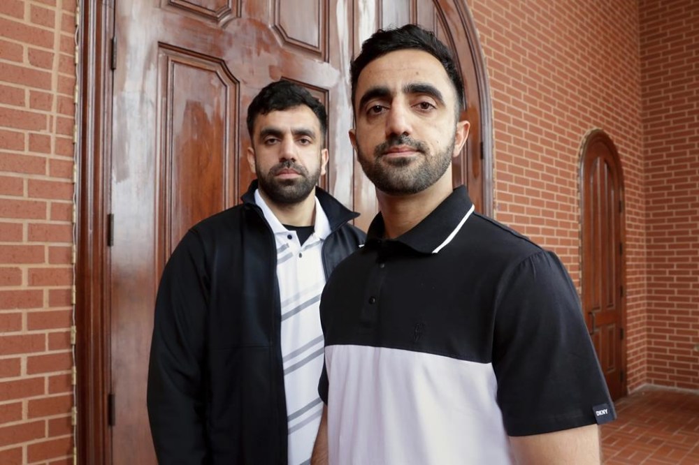 FILE - Brothers Samiullah Safi, left, and Abdul Wasi Safi pose for a picture after Friday prayers outside the Al-Noor Society Mosque, April 7, 2023, in Houston. Abdul Wasi Safi, an Afghan soldier who fled the Taliban and traveled through nearly a dozen countries before being arrested at the Texas-Mexico border and detained for months, has been granted asylum, allowing him to remain in the United States, his brother said Wednesday, Sept. 13. (AP Photo/Michael Wyke, File)