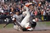 San Francisco Giants' Patrick Bailey, bottom, scores the winning run against Cleveland Guardians catcher Bo Naylor during the tenth inning of a baseball game in San Francisco, Wednesday, Sept. 13, 2023. The Giants won 6-5. (AP Photo/Jeff Chiu)