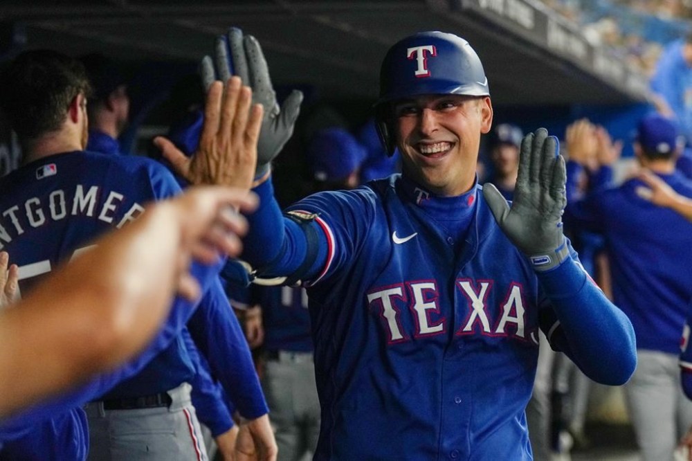 Texas Rangers' Nathaniel Lowe celebrates his three-run home run against the Toronto Blue Jays during fourth inning American League MLB baseball action in Toronto on Wednesday, September 13, 2023. THE CANADIAN PRESS/Nathan Denette