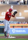 Cincinnati Reds' TJ Friedl celebrates his two-run triple against the Detroit Tigers during the second inning of a baseball game Wednesday, Sept. 13, 2023, in Detroit. (AP Photo/Duane Burleson)