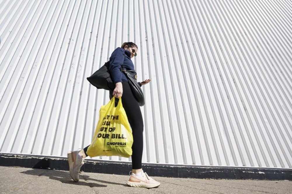 Grocery prices rose 8.5 per cent in July, showing signs of slowing price growth. For months, food price inflation has outpaced overall inflation, which was 3.3 per cent in July. A person leaves a Toronto supermarket with groceries on Wednesday, Oct. 5, 2022. THE CANADIAN PRESS/Alex Lupul