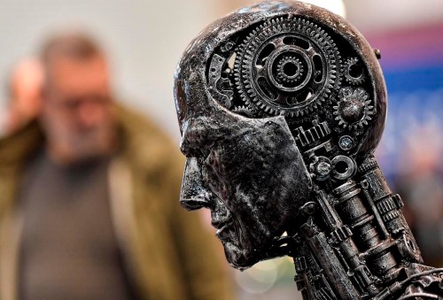 A group representing more than 150 Canadian tech companies is calling on the country to take a sensitive but speedy approach to artificial intelligence. A metal head made of gears symbolizes artificial intelligence, or AI, at the Essen Motor Show in Essen, Germany on Nov. 29, 2019.THE CANADIAN PRESS/AP/Martin Meissner