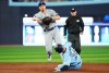 Texas Rangers shortstop Corey Seager (left) forces out Toronto Blue Jays' Matt Chapman (26) at second base as he throws to first during second inning American League MLB baseball action in Toronto on Thursday, September 14, 2023. THE CANADIAN PRESS/Nathan Denette
