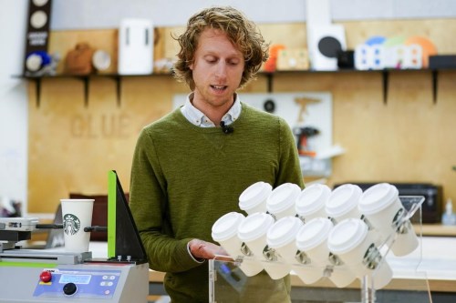 Senior Packaging Engineer Kyle Walker explains a tilt test for cups at the Tryer Center at Starbucks headquarters, Wednesday, June 28, 2023, in Seattle. Technicians examine different parts of the cup to see where less material may be used without weakening it. 