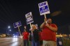 Picketers stand next to a road outside the Stellantis Toledo Assembly Complex early Friday, Sept. 15, 2023, in Toledo, Ohio. Members of the United Auto Workers union began picketing at a General Motors assembly plant in Wentzville, Mo., a Ford factory in Wayne, Mich., near Detroit, and the Stellantis Jeep plant in Toledo. (Jonathan Aguilar/The Blade via AP)