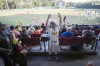 FILE - Savannah Bananas catcher Vinny Rauso, center, tries to get fans to cheer before throwing a free T-shirt to the loudest section, during the team's baseball game against the Florence Flamingos, June 7, 2022, in Savannah, Ga. A new exhibit dedicated to the sport's wackiest team, the Bananas, will open Friday at the Baseball Hall of Fame in Cooperstown, N.Y. (AP Photo/Stephen B. Morton, File)