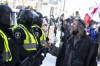 As thousands of demonstrators clogged the streets around Parliament Hill in early 2022, many of them did so with a phone in their hand. A protester records a police line with their phone as police move in to clear downtown Ottawa near Parliament Hill of protesters after weeks of demonstrations on Saturday, Feb. 19, 2022. THE CANADIAN PRESS/Justin Tang
