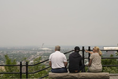 Montreal plans to fundamentally alter its namesake mountain. A group of tourists look east from a lookout on Mount Royal on Monday, June 5, 2023. THE CANADIAN PRESS/Christinne Muschi