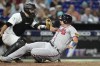 Atlanta Braves' Austin Riley, right, beats the throw to Miami Marlins catcher Jacob Stallings to score during the fifth inning of a baseball game Friday, Sept. 15, 2023, in Miami. (AP Photo/Lynne Sladky)
