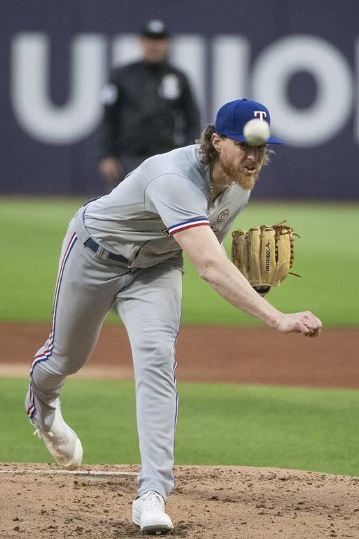 Texas Rangers starting pitcher Jon Gray delivers against the Cleveland Guardians during the first inning of a baseball game in Cleveland, Friday, Sept. 15, 2023. (AP Photo/Phil Long)