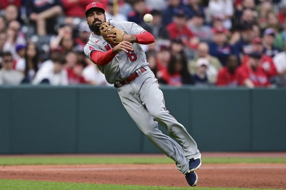 FILE - Los Angeles Angels third baseman Anthony Rendon throws to first for the out on Cleveland Guardians' Cam Gallagher during the fifth inning of a baseball game May 13, 2023, in Cleveland. Rendon says his leg injury is a fractured tibia, not a deep bone bruise. Rendon gave a rare update to reporters Friday, Sept. 15, at Angel Stadium, although he didn’t say whether he’ll be able to return this season. The $245 million slugger has been sidelined since July 4 with the latest injury in his extensive history. (AP Photo/David Dermer, File)