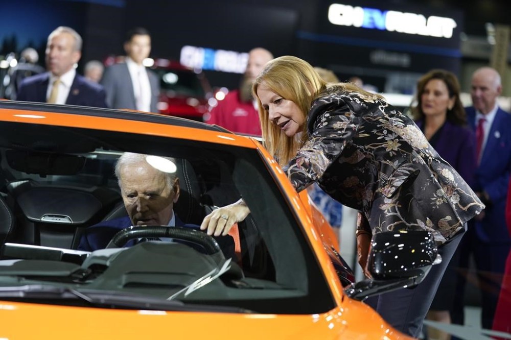 FILE - Mary Barra, CEO of General Motors, talks with President Joe Biden as he sits in a Corvette during a tour of the Detroit Auto Show, Wednesday, Sept. 14, 2022, in Detroit. (AP Photo/Evan Vucci, File)