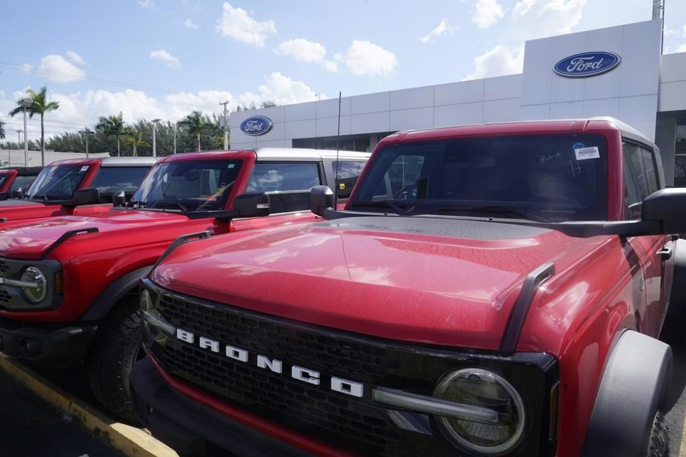 File - Ford Broncos line the front of Gus Machado's Ford dealership on Jan. 23, 2023, in Hialeah, Fla. The strike by auto workers is almost certain to lead to higher prices for car buyers; it's only a matter of whether panic buying will make dealer lots look empty sooner than analysts expect. (AP Photo/Marta Lavandier, File)