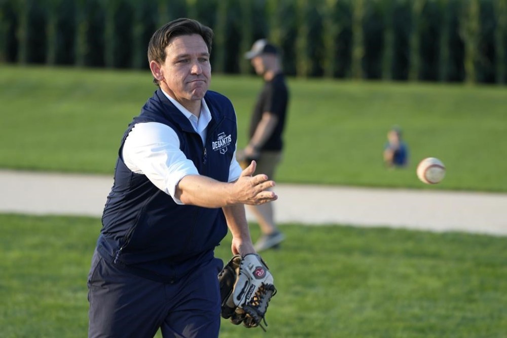 Republican presidential candidate Florida Gov. Ron DeSantis pitches a baseball during a campaign stop at the Field of Dreams movie site, Thursday, Aug. 24, 2023, in Dyersville, Iowa. (AP Photo/Charlie Neibergall)
