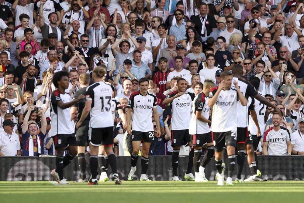 Fulham's Carlos Vinicius celebrates scoring their side's first goal of the game during their English Premier League soccer match against Luton Town at Craven Cottage, London, Saturday, Sept. 16, 2023. (Kieran Cleeves/PA via AP)