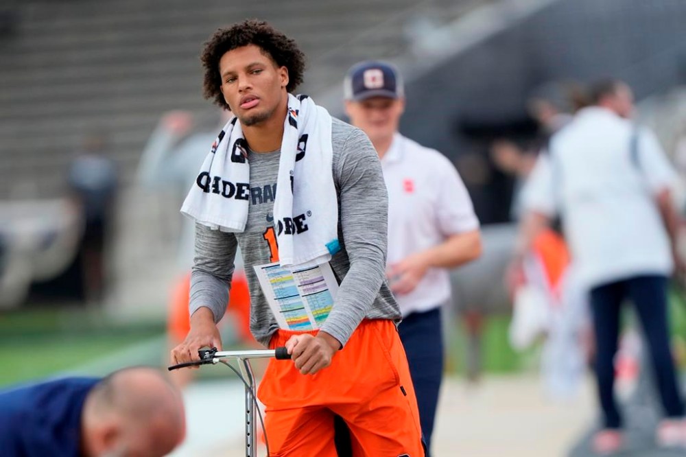 Syracuse tight end Oronde Gadsden II uses a knee scooter during warmups before the team's NCAA college football game against Purdue in West Lafayette, Ind., Saturday, Sept. 16, 2023. Due to an injury suffered while playing Western Michigan, Gadsden is expected to be out the rest of the season. (AP Photo/AJ Mast)