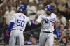 Los Angeles Dodgers' Amed Rosario, right, celebrates with Mookie Betts after scoring off a sacrifice fly hit by Kolten Wong against the Seattle Mariners during the 10th inning of a baseball game Saturday, Sept. 16, 2023, in Seattle. (AP Photo/Maddy Grassy)