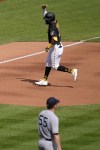 Pittsburgh Pirates' Miguel Andujar, top, celebrates as rounds third base after hitting a solo home run off New York Yankees starting pitcher Carlos Rodon (55) during the fourth inning of a baseball game in Pittsburgh, Sunday, Sept. 17, 2023. (AP Photo/Gene J. Puskar)