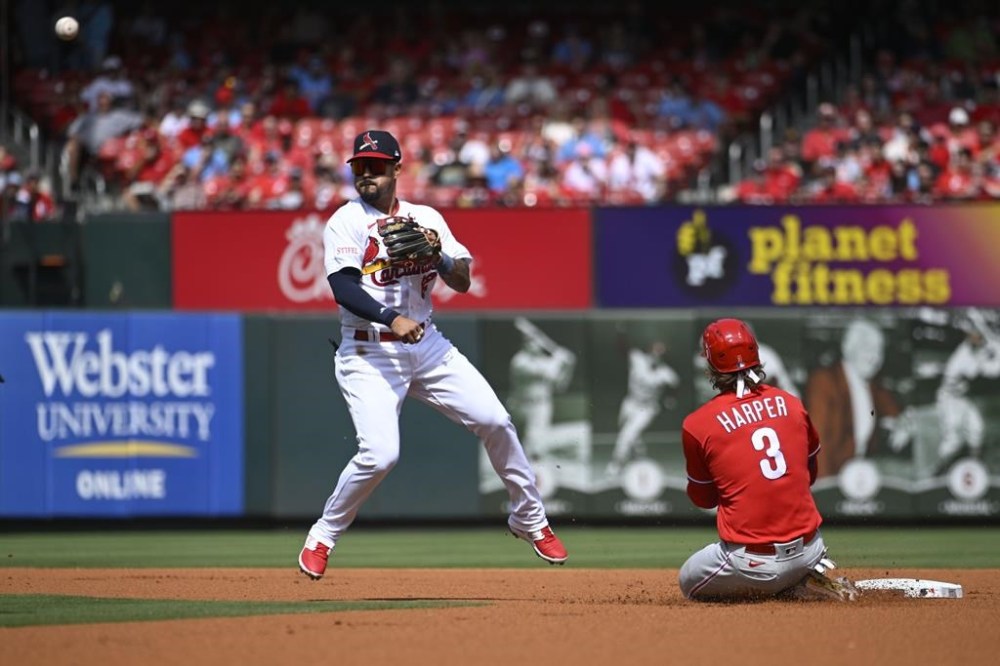 Philadelphia Phillies' Bryce Harper (3), right, is out at second base as St. Louis Cardinals second baseman Juniel Querecuto, left, turns a double play in the first inning of a baseball game, Sunday, Sept. 17, 2023, in St. Louis. (AP Photo/Joe Puetz)