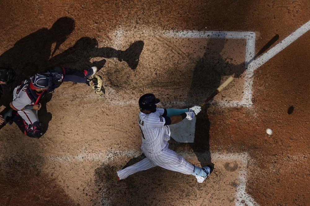 Milwaukee Brewers' Carlos Santana hits a single during the ninth inning of a baseball game against the Washington Nationals Sunday, Sept. 17, 2023, in Milwaukee. (AP Photo/<orry Gash)