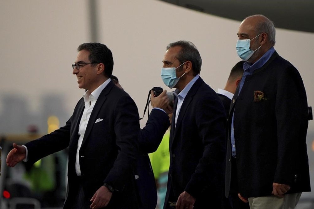 From left, Siamak Namazi, Emad Sharghi and Morad Tahbaz walk away from a Qatar Airways flight that brought them out of Tehran and to Doha, Qatar, Monday, Sept. 18, 2023. Five prisoners sought by the U.S. in a swap with Iran were freed Monday and headed home as part of a deal that saw nearly $6 billion in Iranian assets unfrozen. (AP Photo/Lujain Jo)