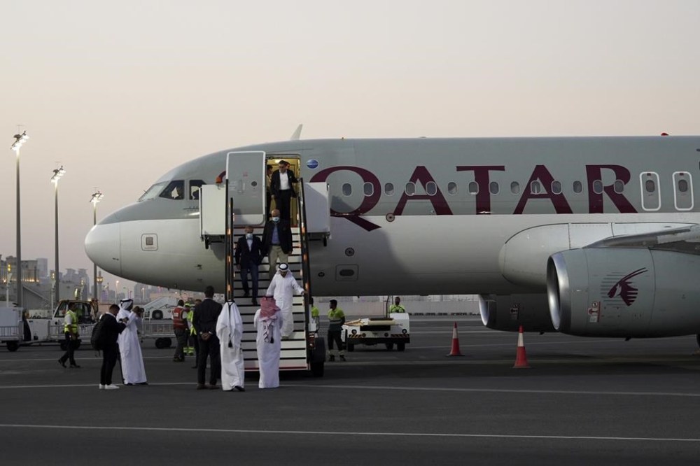 Emad Sharghi, Morad Tahbaz and Siamak Namazi, former prisoners in Iran, walk out of a Qatar Airways flight that brought them out of Tehran and to Doha, Qatar, Monday, Sept. 18, 2023. Five prisoners sought by the U.S. in a swap with Iran were freed Monday and headed home as part of a deal that saw nearly $6 billion in Iranian assets unfrozen. (AP Photo/Lujain Jo)