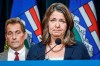 Alberta Premier Danielle Smith, right, speaks to the media about an E. coli outbreak at several Calgary daycares as Dr. Mark Joffe, Alberta chief medical officer of health, looks on in Calgary, Alta., Friday, Sept. 15, 2023. There are now 348 lab-confirmed cases of E. coli involving numerous Calgary daycares, and officials say the outbreak appears to have peaked. THE CANADIAN PRESS/Jeff McIntosh