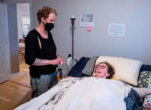 Jen Powley talks with Rae Boudreau, left, a personal care worker, at her home in Halifax on Wednesday, Nov.16, 2022. Powley, an author and prominent Nova Scotia advocate for people with disabilities, has died at the age of 45. THE CANADIAN PRESS/Andrew Vaughan